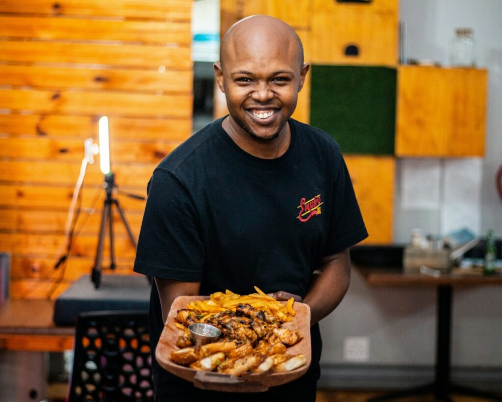 a person holding a tray of food