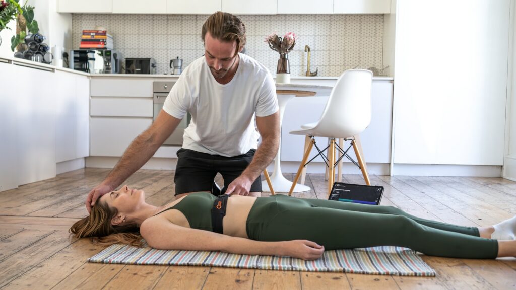 a woman laying on the floor in front of a man