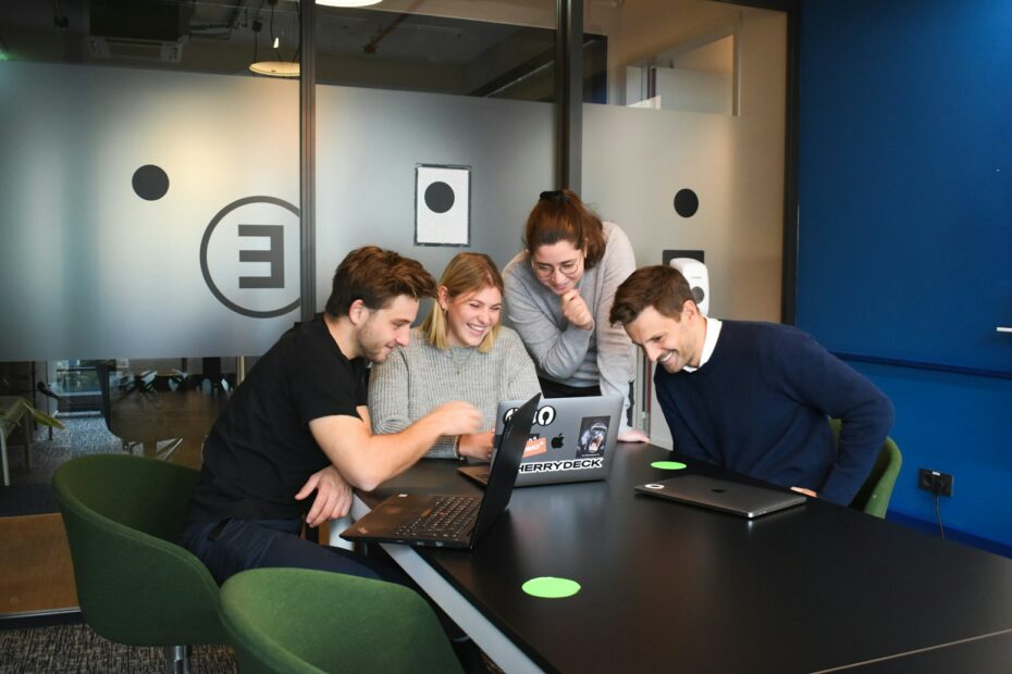 people sitting on chair in front of laptop computers