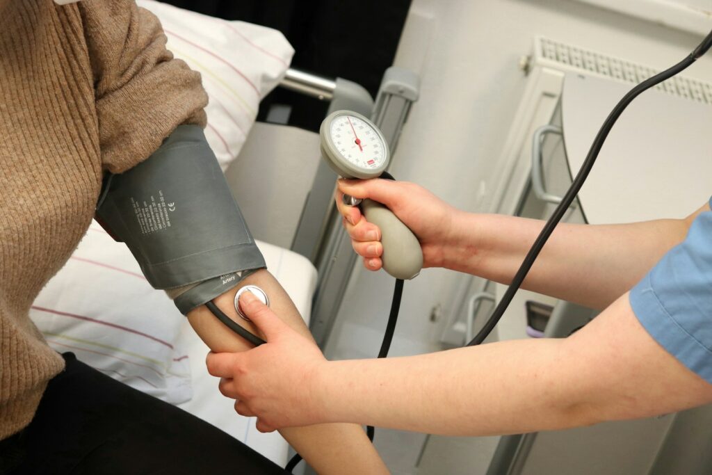 A person with a blood pressure device in their hand