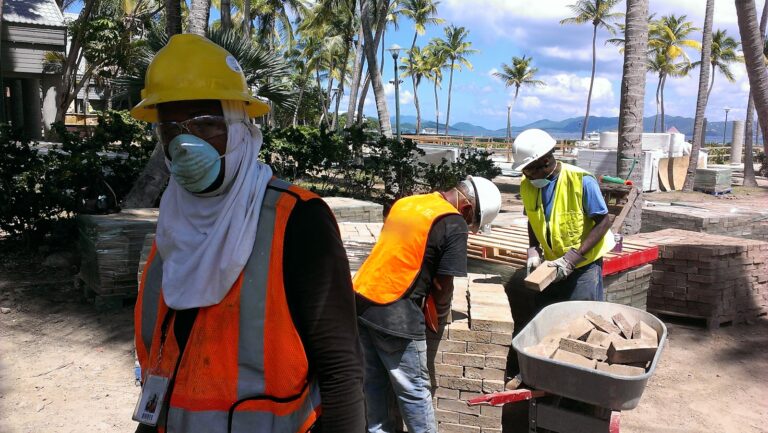 a group of people wearing safety vests and masks