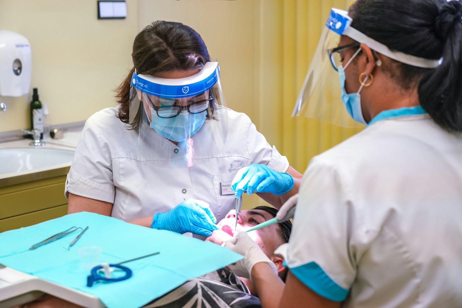 a woman getting her teeth checked by a dentist