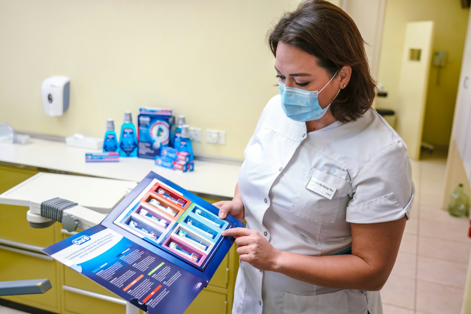 a woman wearing a face mask and holding a magazine